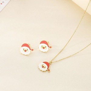 Detailed view of gold stainless steel necklace and earrings set with red enamel Santa Claus