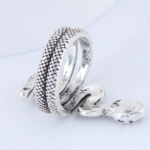 Vintage silver snake wrap ring with gothic style textured details on grey background