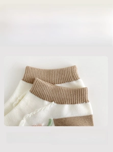 Detail of high-elastic ribbed cuffs on brown and white combed cotton socks