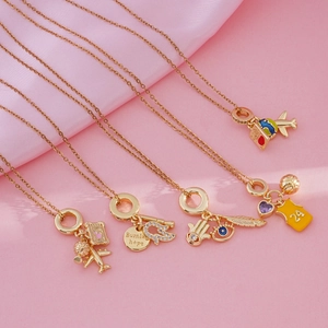 Five gold necklaces with diverse charms including travel, sports, and celestial themes
