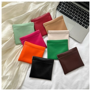 Flat lay of colorful mini faux leather pouches with squeeze metal closure for small items