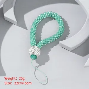 Beaded light green wrist phone strap with a large sparkling rhinestone crystal ball