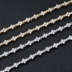 Detail of hip hop clover necklaces with gold and silver finishes and pavé zircons
