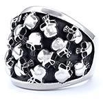 Macro view showing detailed punk gothic skull carvings on a vintage stainless steel ring