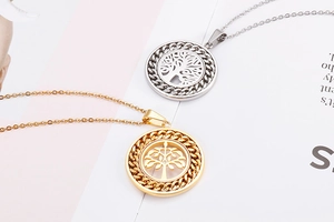 Detailed view of hollow tree of life pendants in gold and silver finish with O-chains