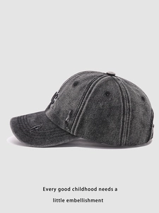Side view of washed denim baseball cap with NY embroidery and distressed details