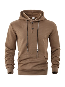 Detail of brown knit hoodie showing herringbone texture, button collar and bicolor drawstrings