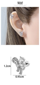 Macro view of silver bow stud earring with zircons showing 1.2cm height and 0.95cm width
