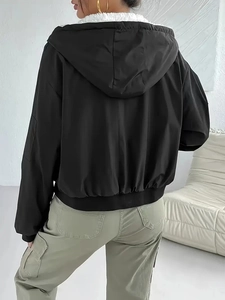 Women's black hooded jacket with warm white fleece lining and cinched waist hem