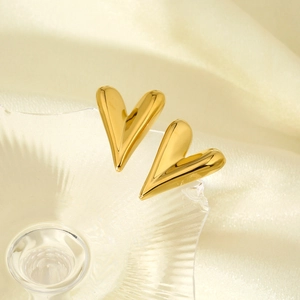 Macro detail of 316L stainless steel heart studs with luxury 16K gold polished finish