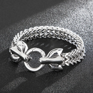 Detail of silver wolf head claps on heavy wheat chain bracelet for men in punk style