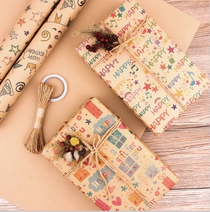 Detail of kraft paper gift wrap set with music notes, twine rope and dried flowers