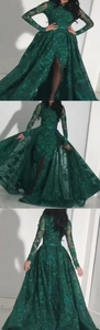 Detail view of dark green lace evening dress with long sleeves and high slit design