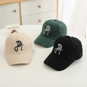 Detailed close-up of dinosaur skeleton embroidery on cotton baseball caps in three colors