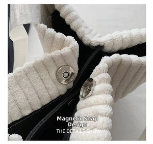 Detail view of magnetic snap closure and black lining on white corduroy tote bag