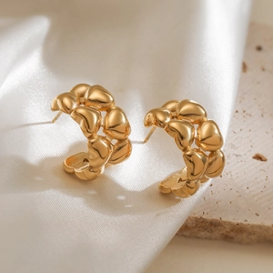 Polished gold-plated stainless steel C-shaped hoop earrings with 3D heart-shaped pattern