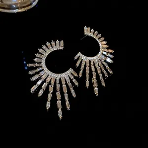 Elegant silver-tone C-shaped earrings featuring radiating cubic zirconia stones