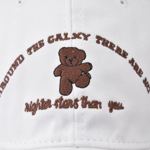 White cotton baseball cap with embroidered brown bear and galaxy quote detail