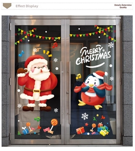 Detail of Christmas window stickers with Santa, penguin and Merry Christmas text decor