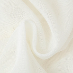 Detailed close-up of white ruffled mesh fabric with delicate V-neck tie blouse texture