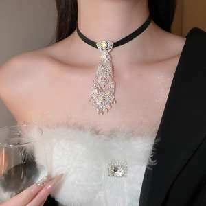 Close-up of rhinestone tie tassel choker with iridescent crystals on black band