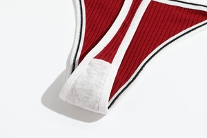 Macro detail of red ribbed cotton thong showing white contrast binding and soft cotton crotch