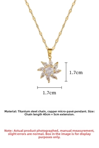 Detail view of gold titanium steel floral pendant necklace with micro-inlaid cubic zirconia