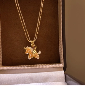 Close-up of gold double-chain necklace with zircon horse pendant in a velvet jewelry box