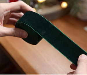 Close-up of high-quality dark green velvet ribbon for Christmas gift wrapping and crafts