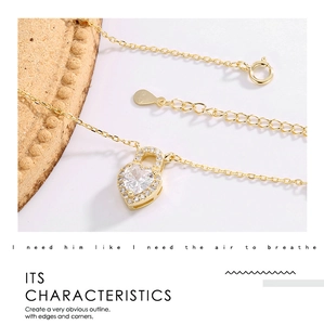 Macro shot of gold-plated heart lock pendant with sparkling zircon and lobster clasp