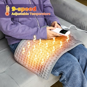 Gray electric heating pad with 9-speed controller used on legs for cozy warmth