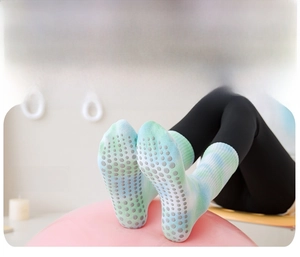 Close-up of blue-green tie-dye yoga socks with anti-slip silicone dots on sole