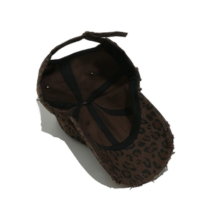 Detailed interior of a leopard print baseball cap with distressed edges and sturdy black lining