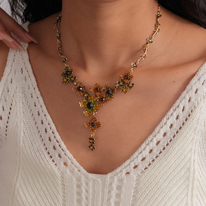 Detail of vintage flower tassel necklace with colorful crystals on a gold-tone base
