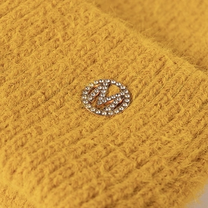 Winter mustard yellow knit beanie with sparkling rhinestone M metal emblem detail