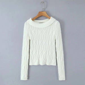 Detailed close-up of white long-sleeved cable knit sweater with vintage texture detail
