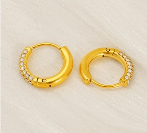 Detail of 18K gold-plated stainless steel huggie earrings with sparkling crystals