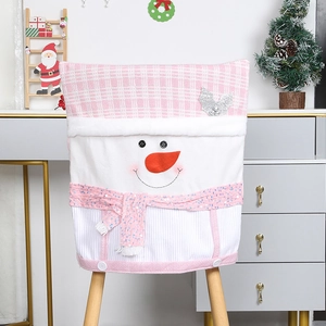 Detailed view of pink plaid Christmas chair cover with cute snowman face and scarf decor