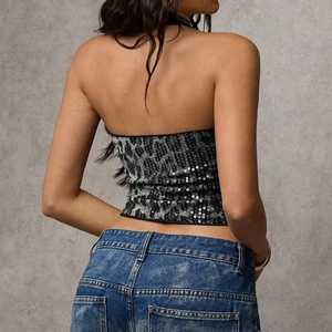 Detailed back view of a sequined leopard print crop top with stylish halter neck design