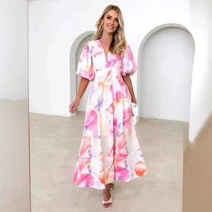 Pink floral print V-neck maxi dress with puff sleeves and A-line waist in a white scene