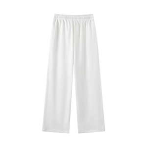 Detail of high-waisted white wide-leg trousers featuring a comfortable elastic waistband