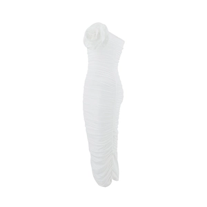 Detail view of 3D floral decoration and ruched fabric on a white tube dress