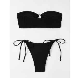 Close-up of black strapless bikini set with side-tie bottoms and textured seersucker fabric