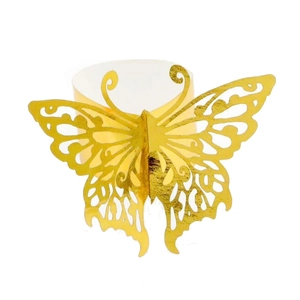 Detail of laser-cut butterfly napkin ring in reflective gold finish for wedding decor
