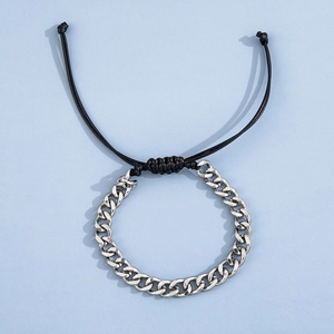 Detail of silver stainless steel Cuban link chain with adjustable black braided rope cord