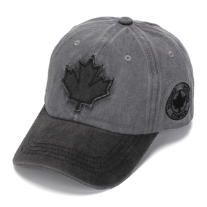 Detail of washed grey baseball cap with 3D maple leaf embroidery and side logo.