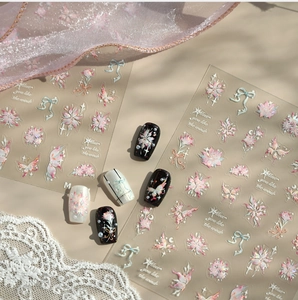 Detailed view of floral and butterfly nail stickers on various base colors with lace decor
