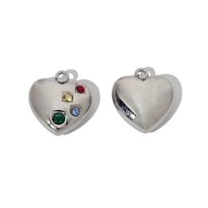 Detailed macro view of heart-shaped stainless steel pendants with colorful gemstones