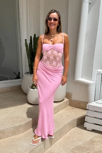 Close-up of pink lace bodice detail and high-waist sheer dress design on a model