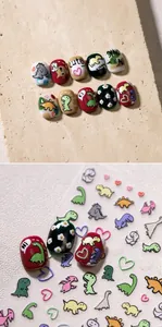 Macro detail of 3D embossed dinosaur nail stickers with cute matte textured patterns